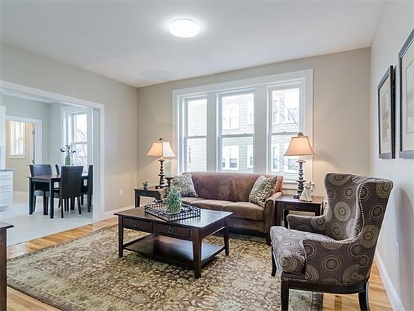 4 Leicester Street, Unit 4 Boston, MA 02135 - Photo 3 of 12 a living room with furniture a rug and a window