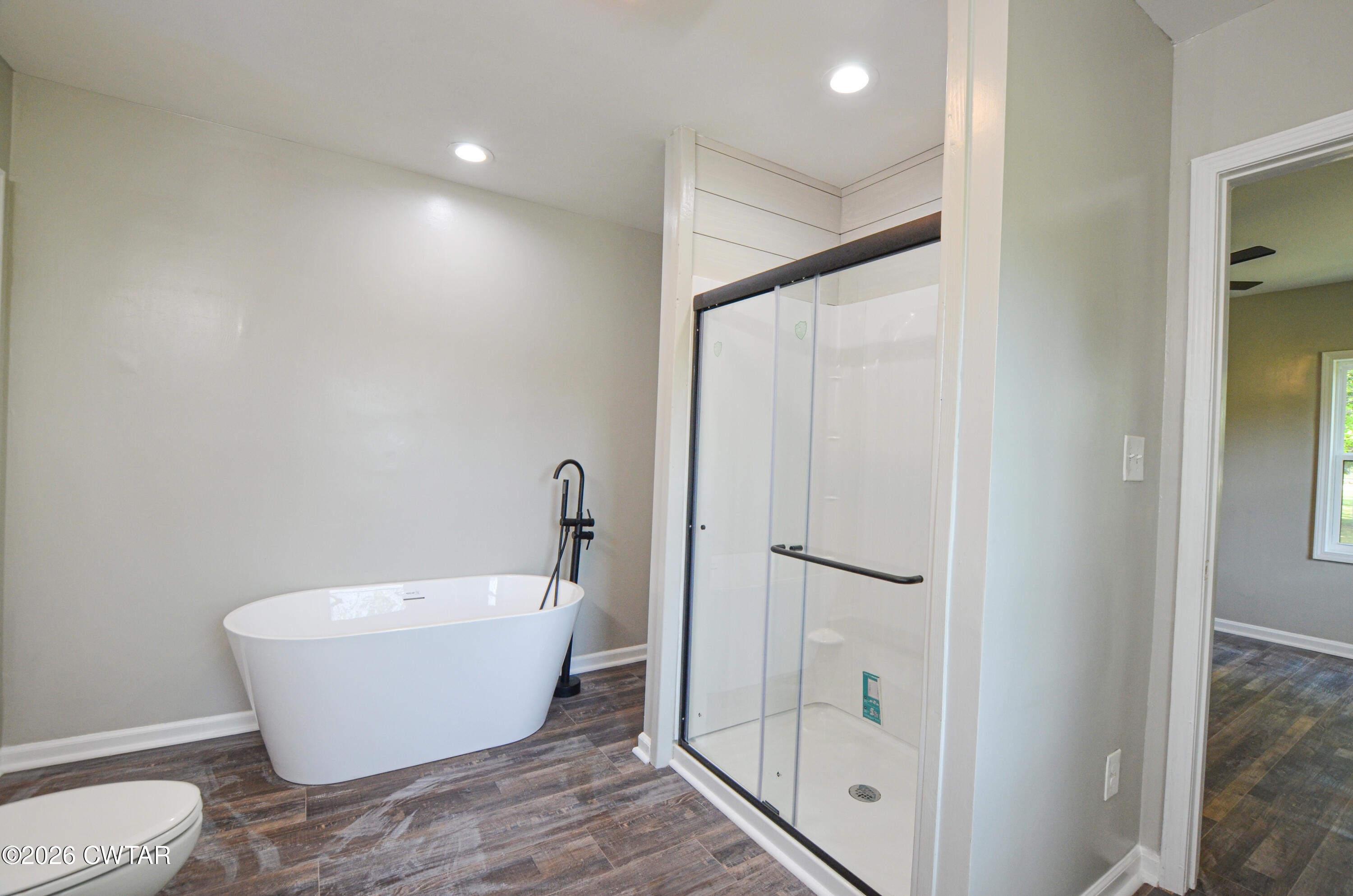 4177 Gum Flat Road Bells, TN 38006 - Photo 22 of 30 a white bath tub sitting next to a bathroom