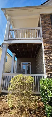 a view of a porch with wooden floor and fence