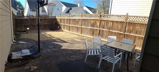 a view of a room with wooden floor and a window