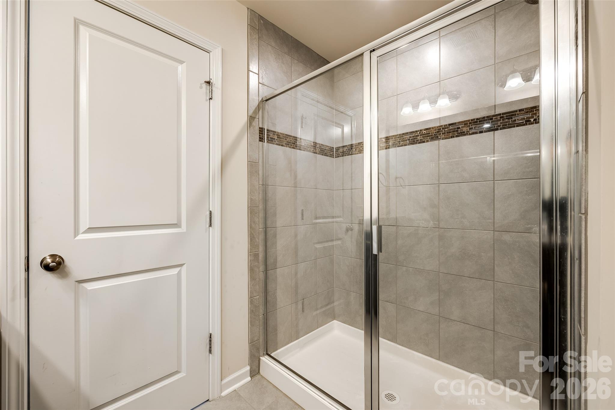524 Hunters Dance Road Fort Mill, SC 29708 - Photo 11 of 34 a bathroom with a glass shower door
