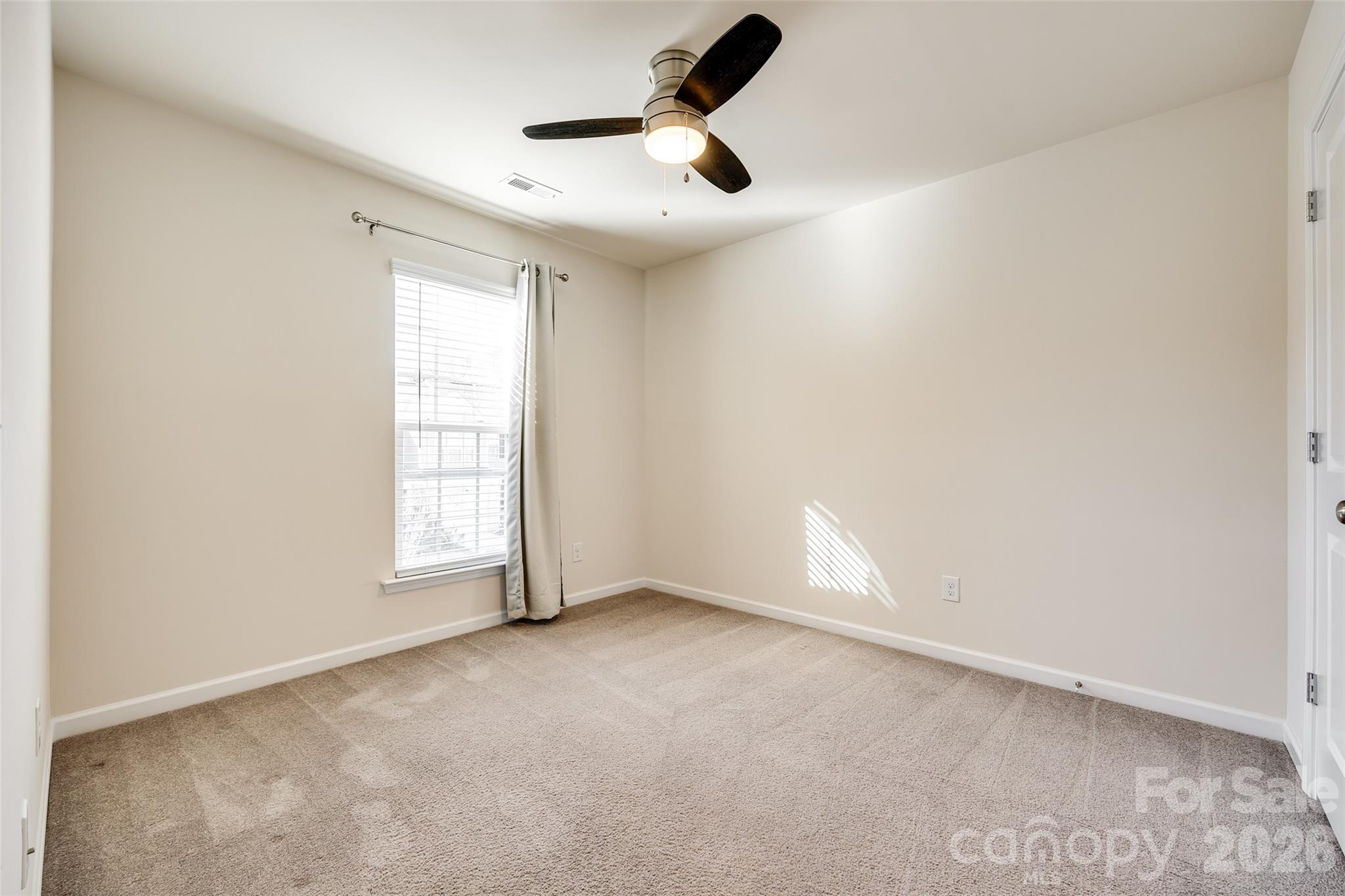 524 Hunters Dance Road Fort Mill, SC 29708 - Photo 16 of 34 an empty room with a window and a fan