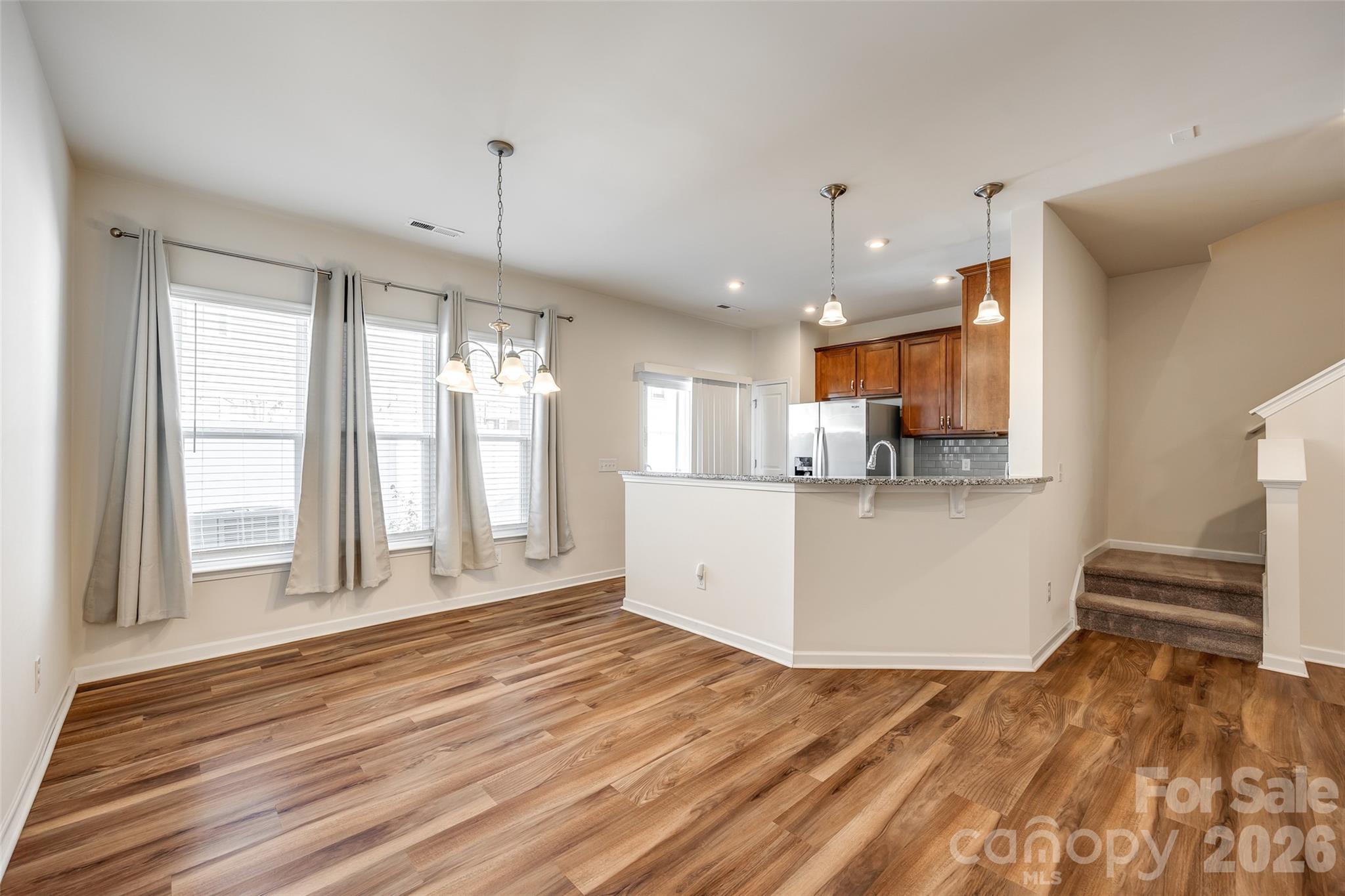 524 Hunters Dance Road Fort Mill, SC 29708 - Photo 19 of 34 a view of a kitchen with wooden floor and windows