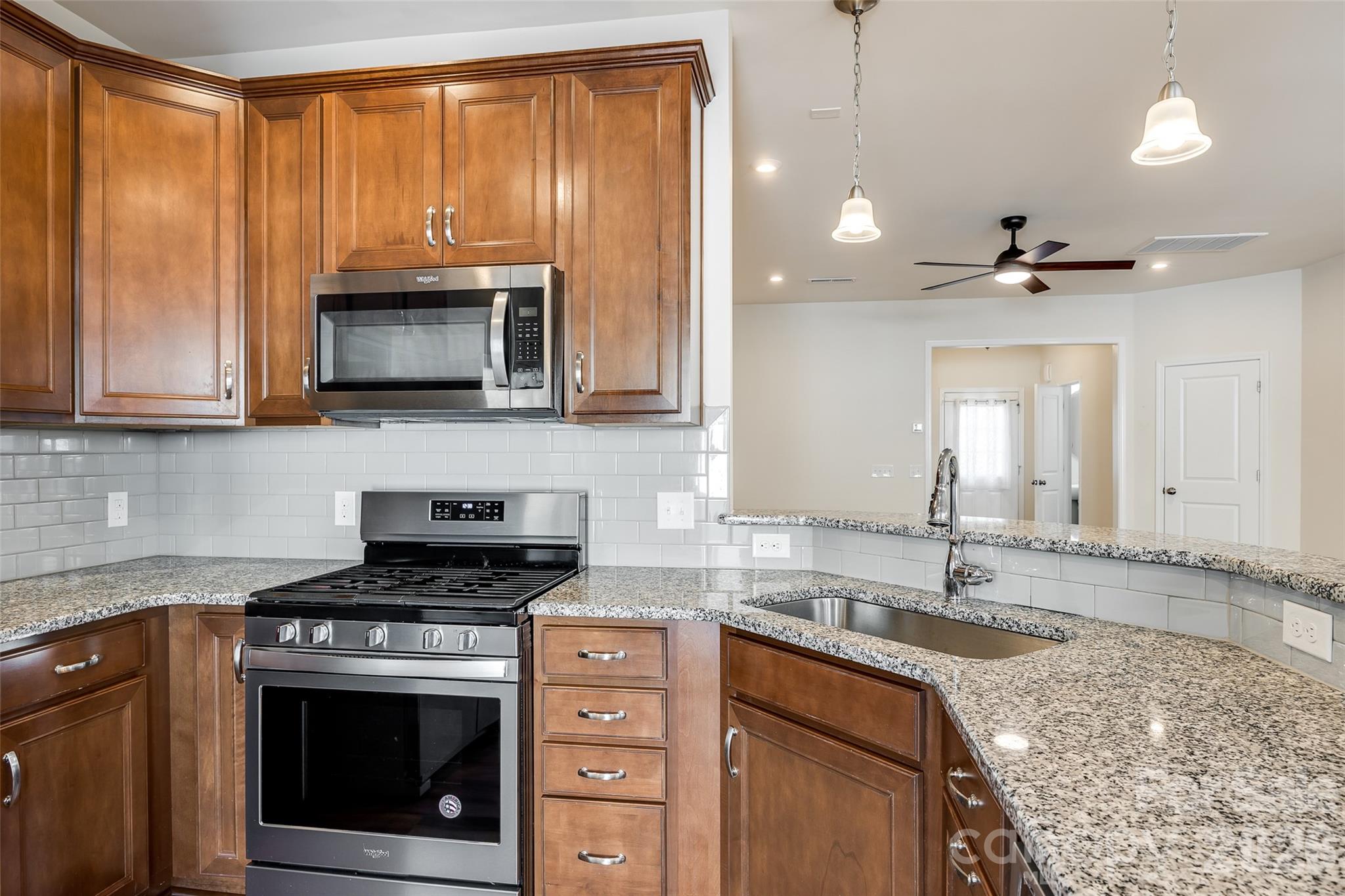 524 Hunters Dance Road Fort Mill, SC 29708 - Photo 30 of 34 a kitchen with granite countertop a sink stainless steel appliances and cabinets