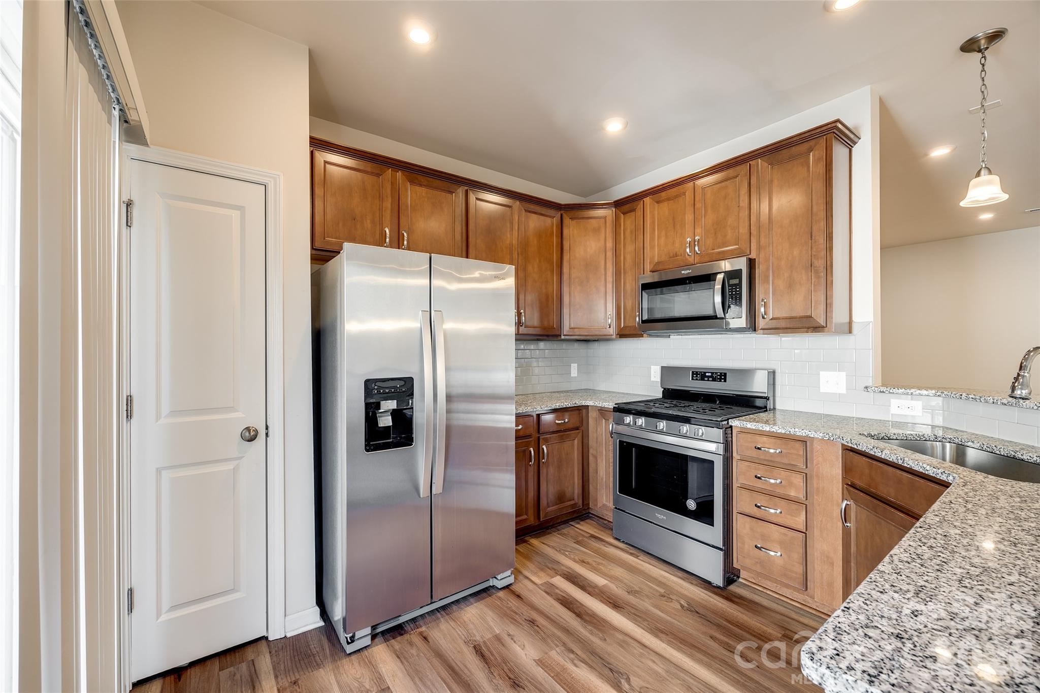524 Hunters Dance Road Fort Mill, SC 29708 - Photo 5 of 34 a kitchen with stainless steel appliances granite countertop a refrigerator stove and sink