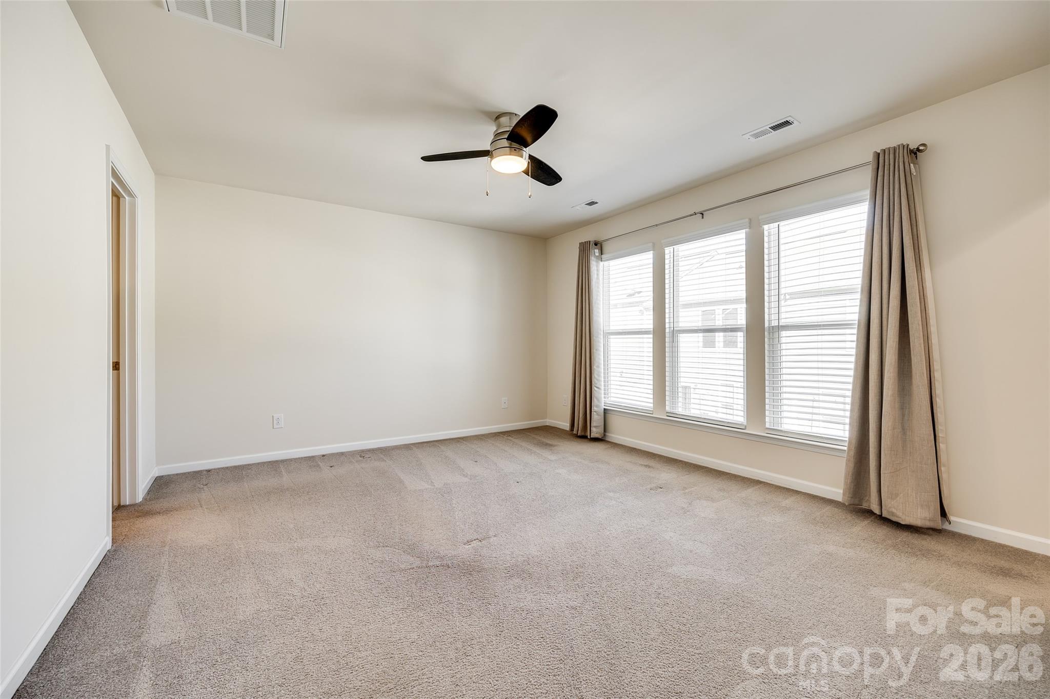 524 Hunters Dance Road Fort Mill, SC 29708 - Photo 9 of 34 an empty room with windows and fan