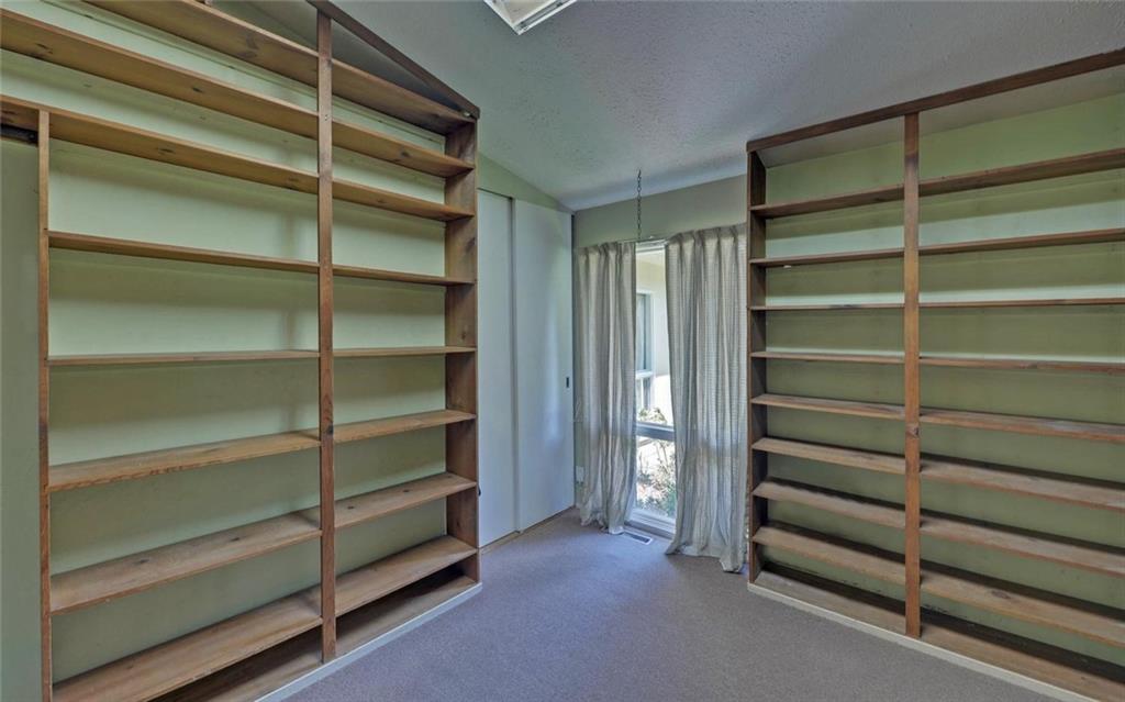 1858 Pinecrest Road Gainesville, GA 30501 - Photo 17 of 55 a view of walk in closet with empty racks