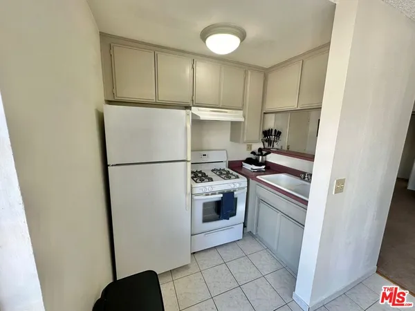 a kitchen with a sink appliances and cabinets