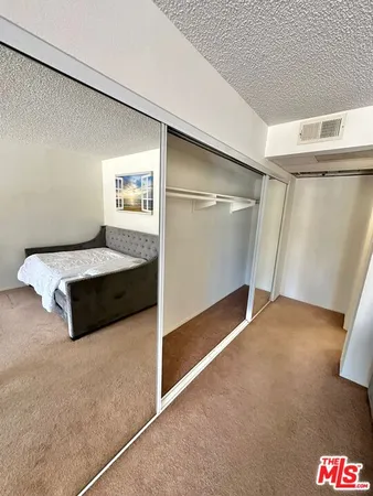 a bedroom with a bed and a walk in closet