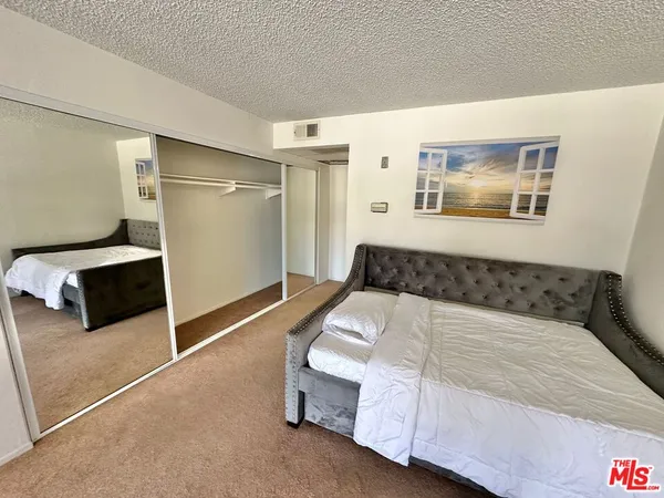 a bedroom with a bed and wall painting