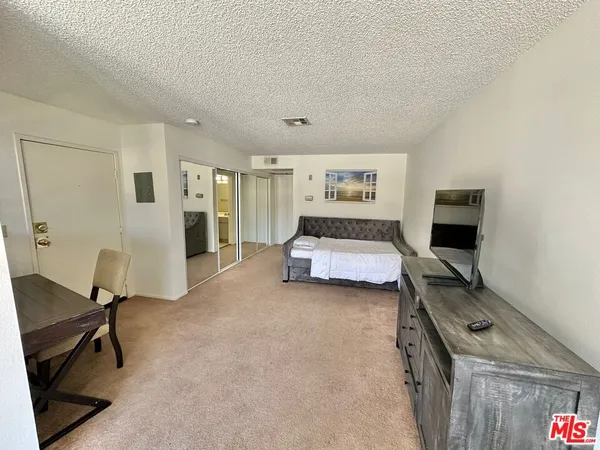 a bedroom with a bed and a chair