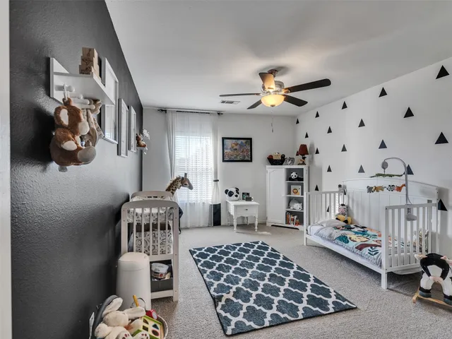a bedroom with furniture and a chandelier