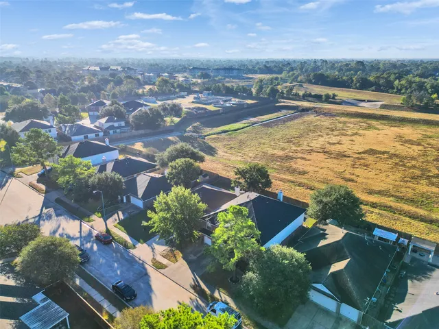 an aerial view of residential houses with outdoor space