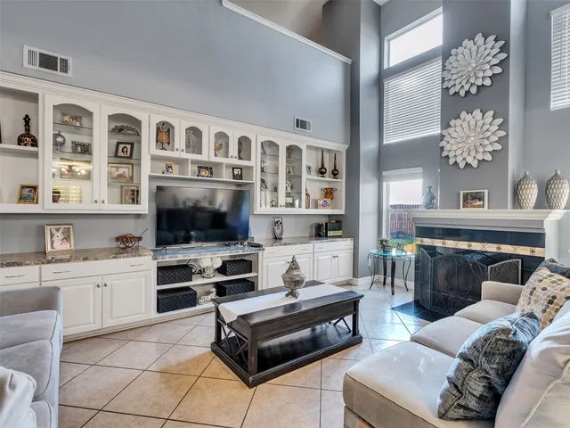 a living room with furniture a flat screen tv and kitchen view