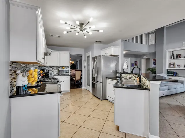 a kitchen with refrigerator and cabinets