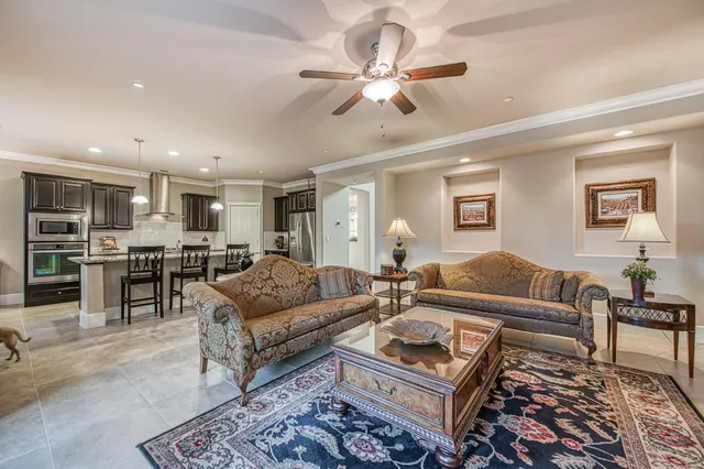 a living room with furniture and a view of kitchen
