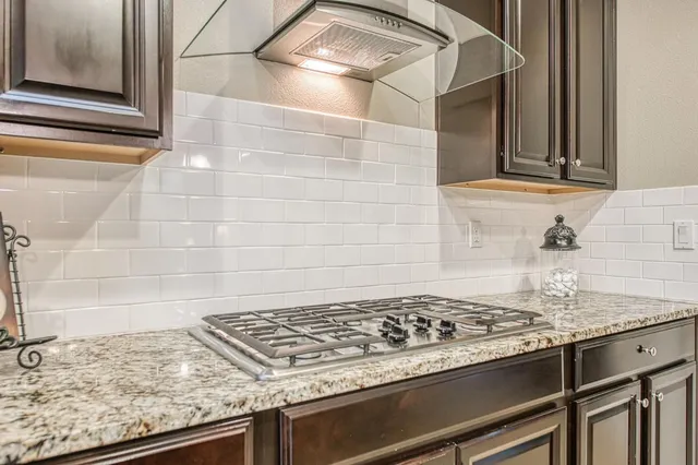 a stove top oven sitting inside of a kitchen