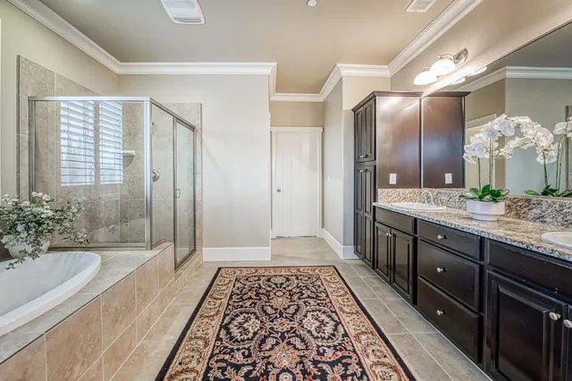 a bathroom with a double vanity sink and a bathtub