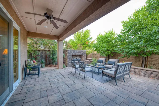 a view of a patio with a dining table and chairs