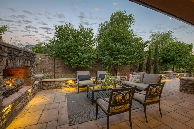 a view of backyard with seating area and green space