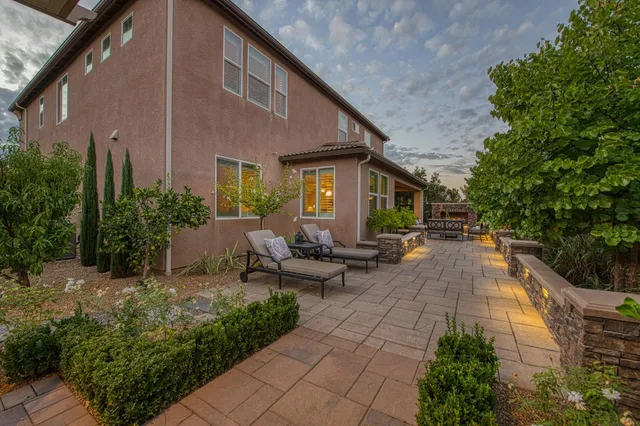 a view of a house with sitting area and garden