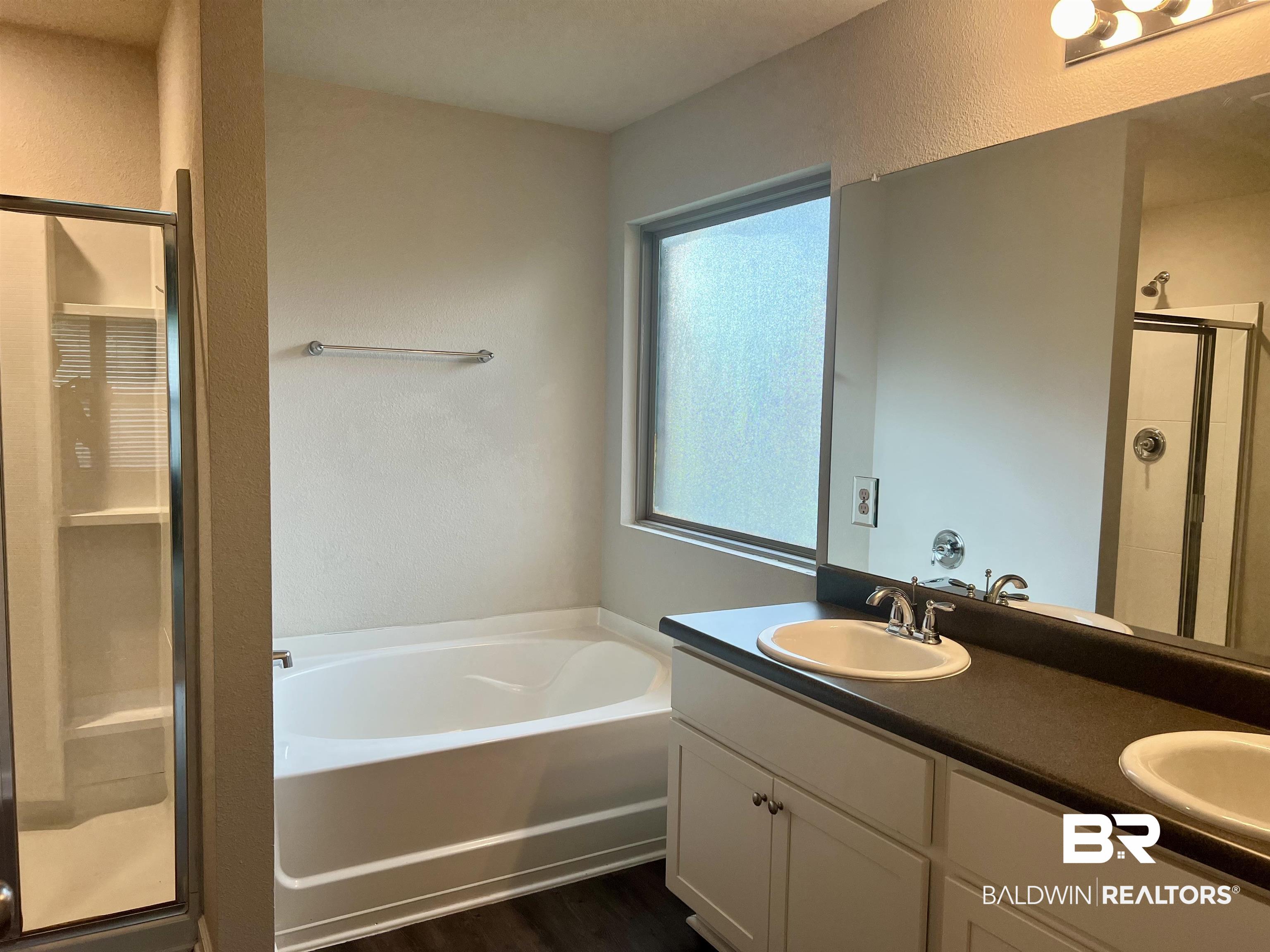 1612 Abbey Loop Foley, AL 36535 - Photo 19 of 30 Bathroom featuring vanity, separate shower and tub, and wood-type flooring