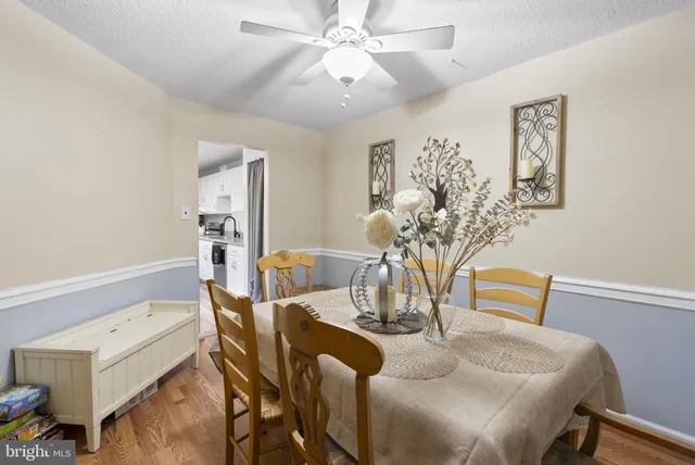 a dining room with furniture and wooden floor