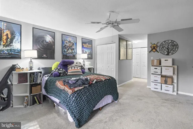 a bedroom with a bed and ceiling fan