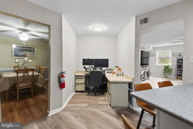 a very nice looking open dining room with kitchen island