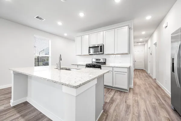 an empty room with windows and ceiling fan