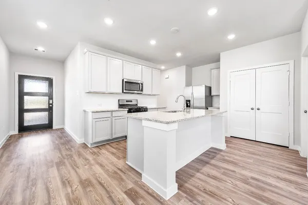 a view of a kitchen with a dishwasher and wooden floor