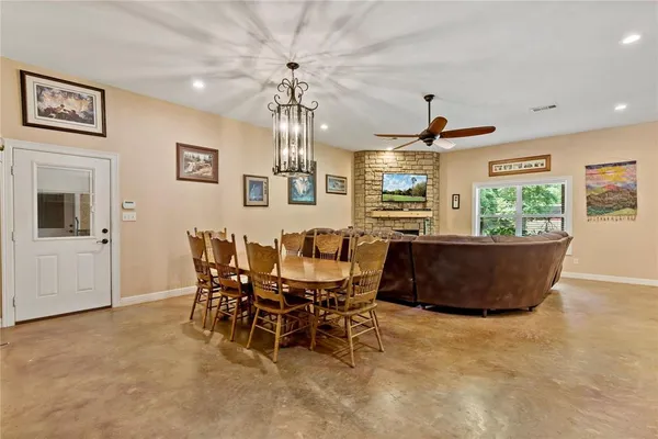 a view of a dining room with furniture and chandelier