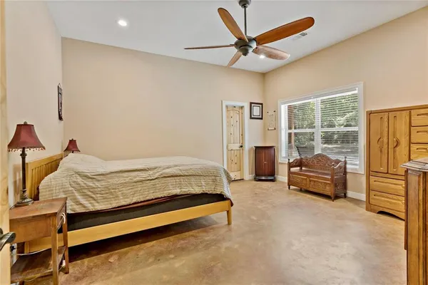 a bedroom with a bed and a couch