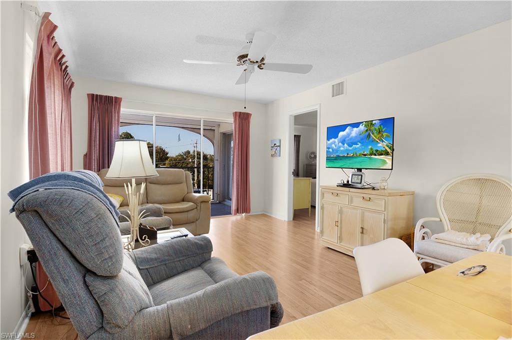 5 High Point Circle West, Unit 313 Naples, FL 34103 - Photo 1 of 24 a living room with furniture and a flat screen tv
