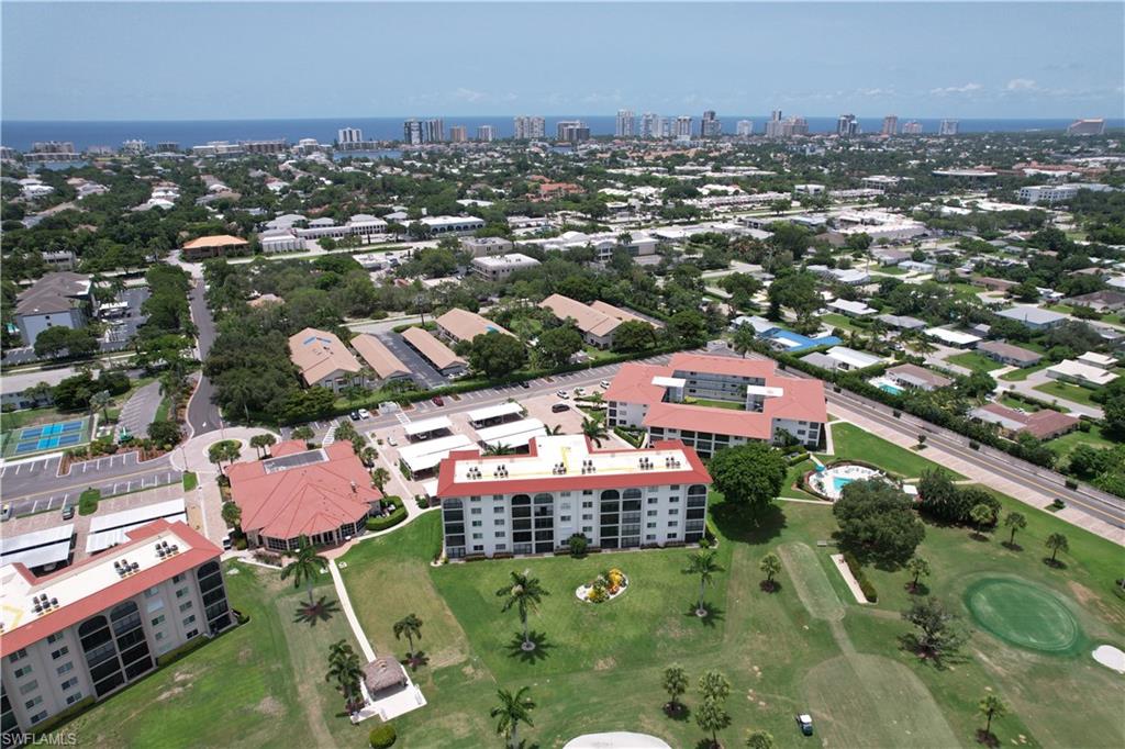 5 High Point Circle West, Unit 313 Naples, FL 34103 - Photo 11 of 24 an aerial view of residential houses with outdoor space