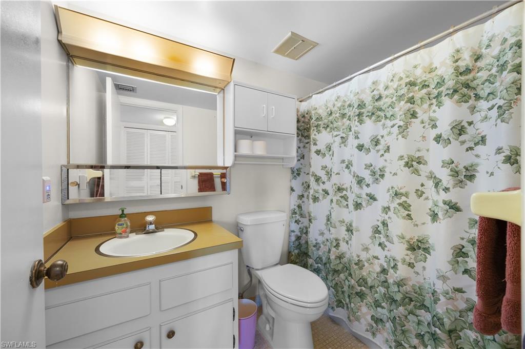 5 High Point Circle West, Unit 313 Naples, FL 34103 - Photo 15 of 24 a bathroom with a sink and a mirror