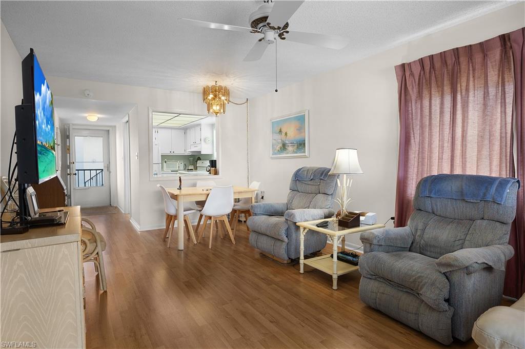 5 High Point Circle West, Unit 313 Naples, FL 34103 - Photo 2 of 24 a living room with furniture kitchen view and a large window