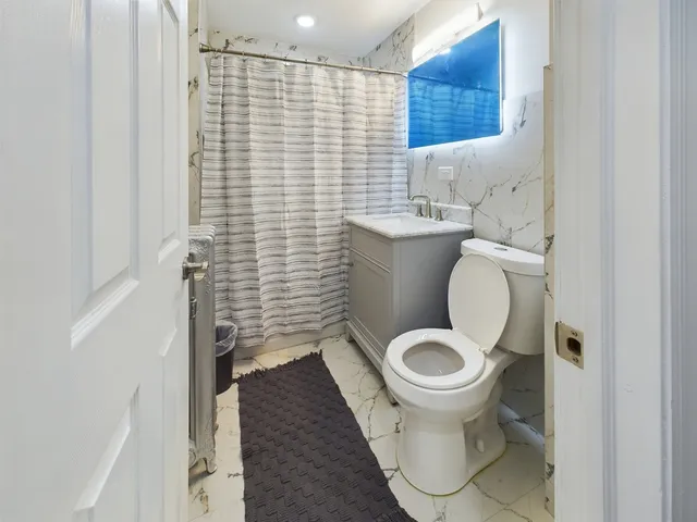 a bathroom with a toilet and a sink