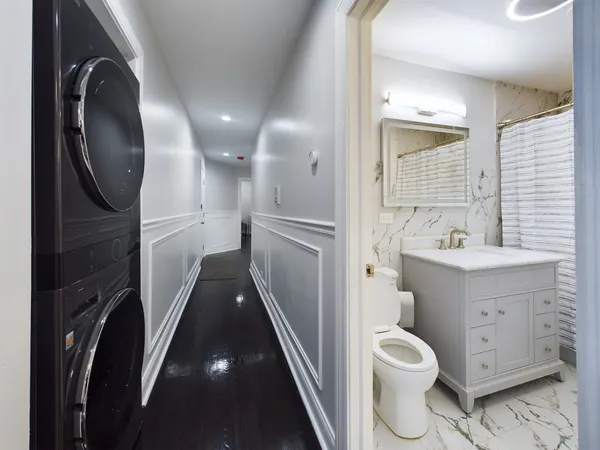 a bathroom with a toilet sink and mirror