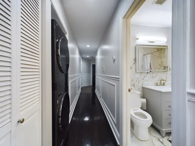 a bathroom with a toilet sink and a mirror