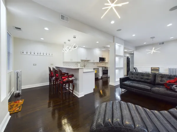 a view of a dining room with furniture and wooden floor