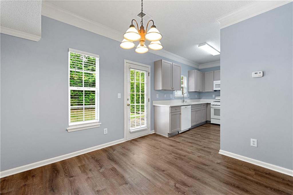 5654 Lawley Road Alpharetta, GA 30022 - Photo 12 of 29 a view of a kitchen with a stove cabinets and wooden floor