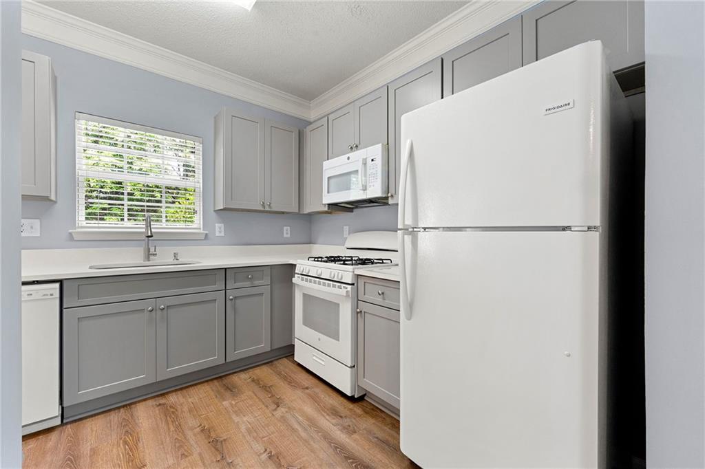 5654 Lawley Road Alpharetta, GA 30022 - Photo 16 of 29 a white refrigerator freezer sitting in a kitchen
