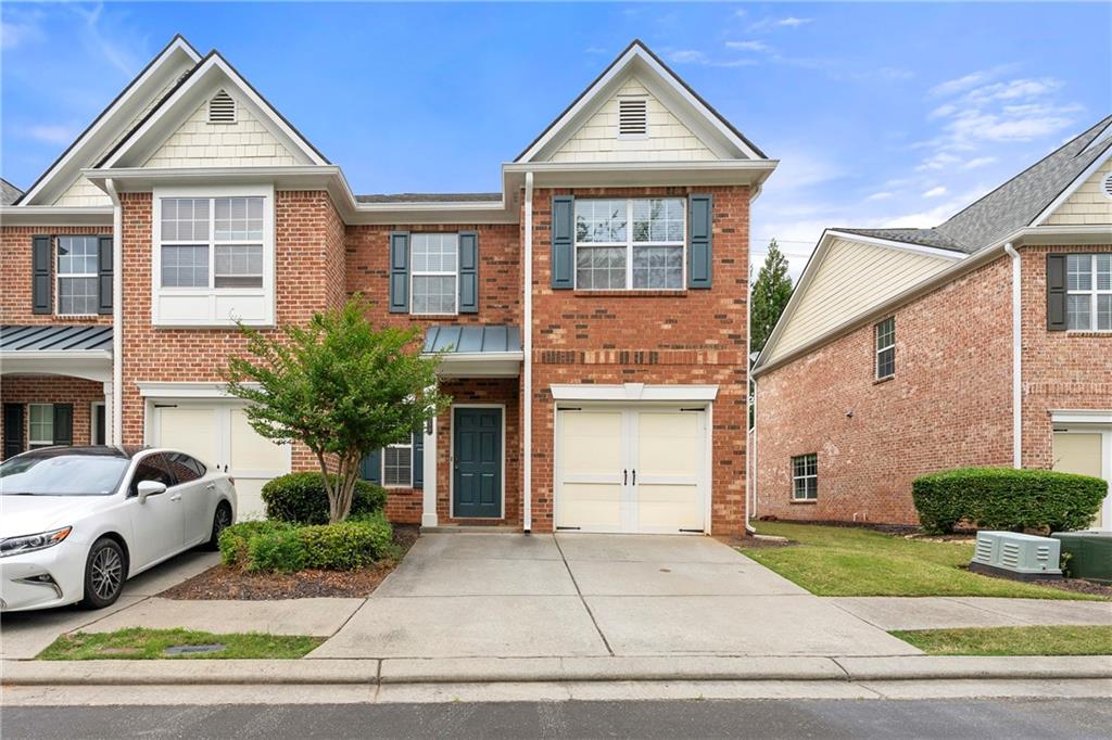 5654 Lawley Road Alpharetta, GA 30022 - Photo 2 of 29 a front view of a house with a yard and garage