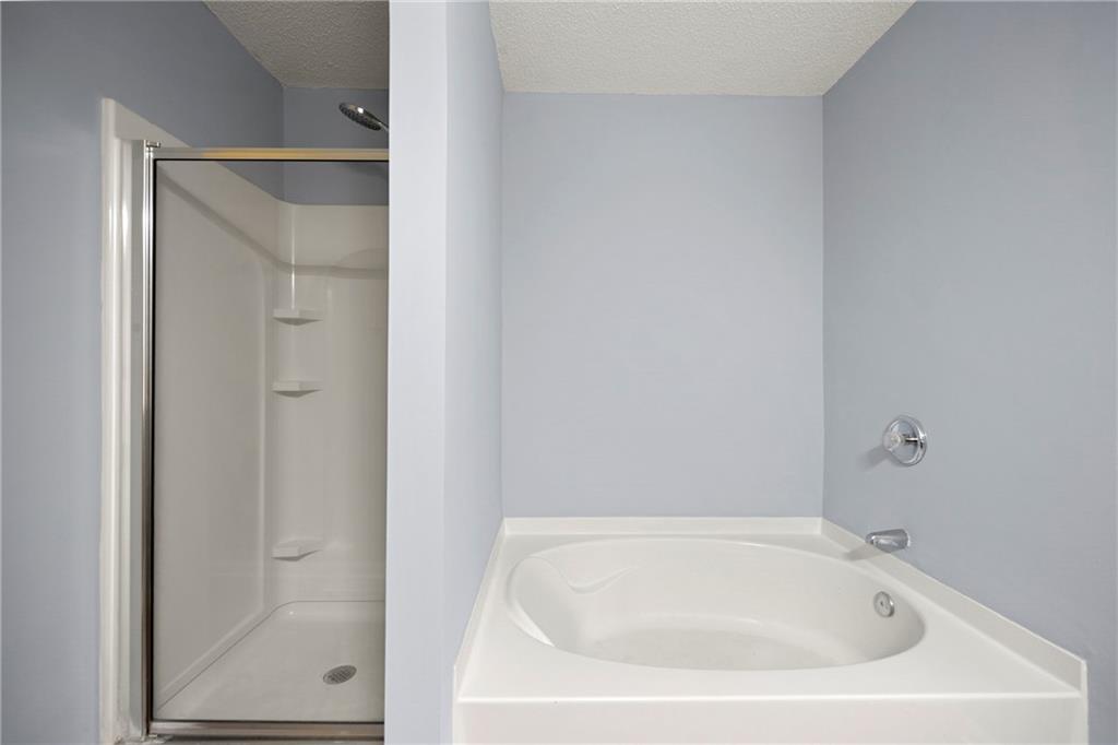 5654 Lawley Road Alpharetta, GA 30022 - Photo 25 of 29 a white bath tub sitting next to a shower