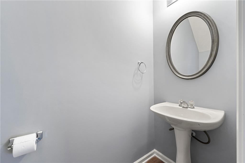 5654 Lawley Road Alpharetta, GA 30022 - Photo 7 of 29 a bathroom with a sink and a mirror