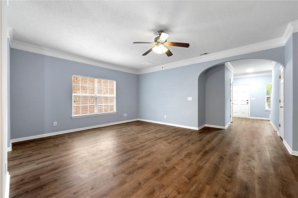 5654 Lawley Road Alpharetta, GA 30022 - Photo 10 of 29 a view of an empty room with wooden floor and a window