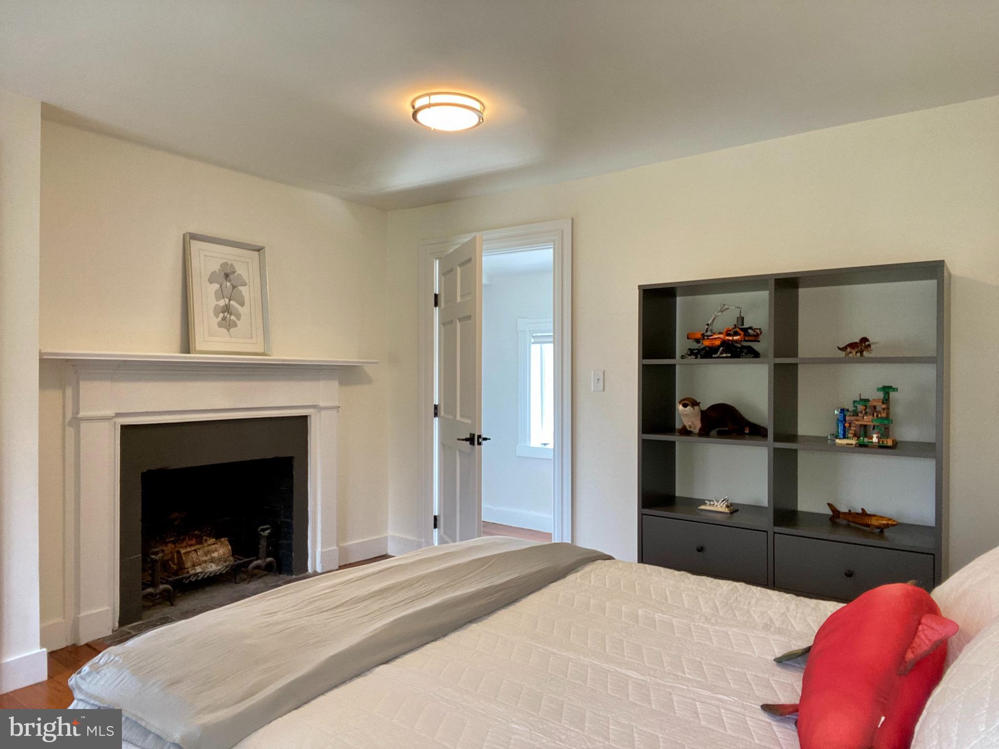 121 Upnor Road Baltimore, MD 21212 - Photo 60 of 79 a bedroom with a bed and a fireplace