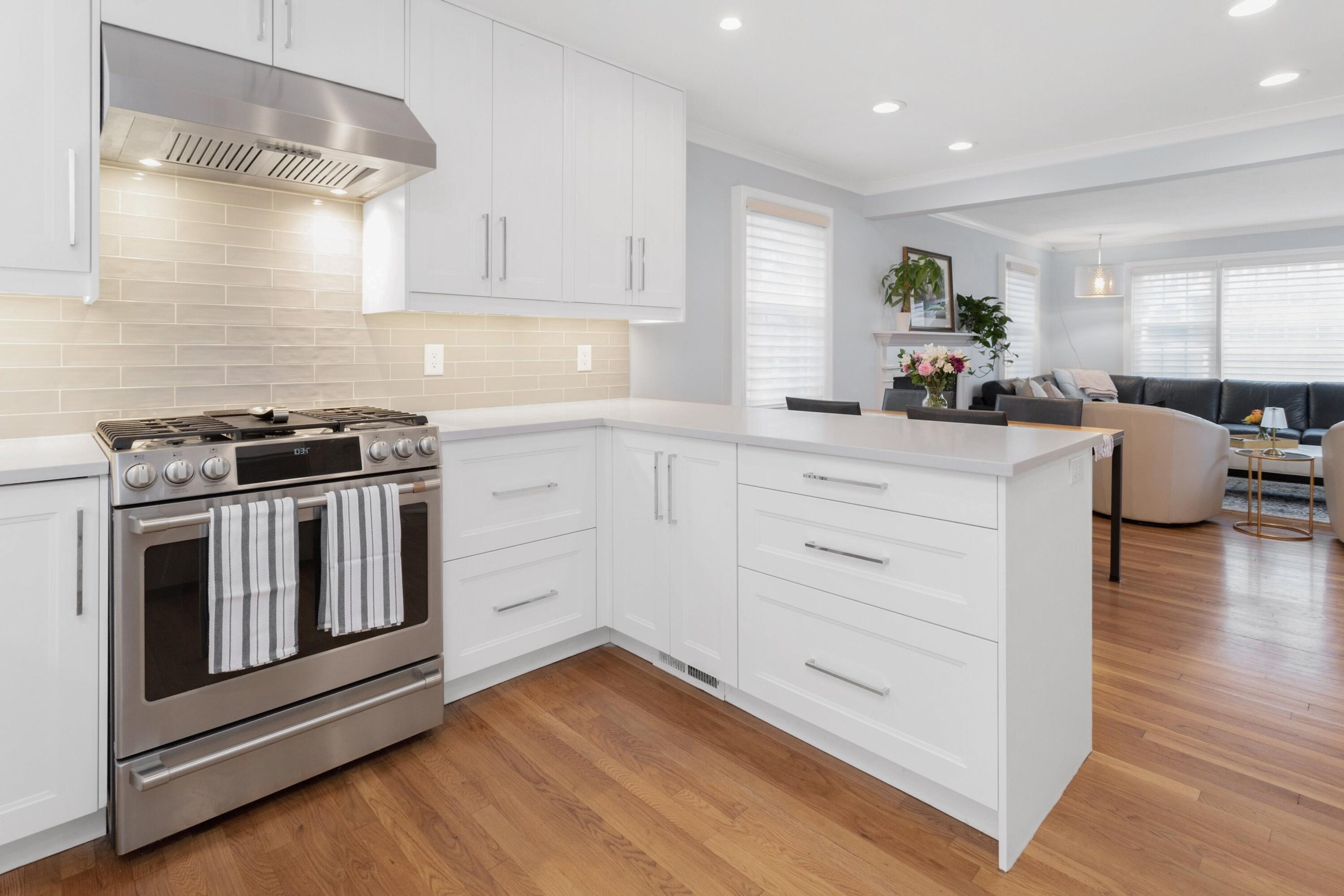 103 Hollow Tree Ridge Road Darien, CT 06820 - Photo 12 of 35 a kitchen with white cabinets and wooden floor