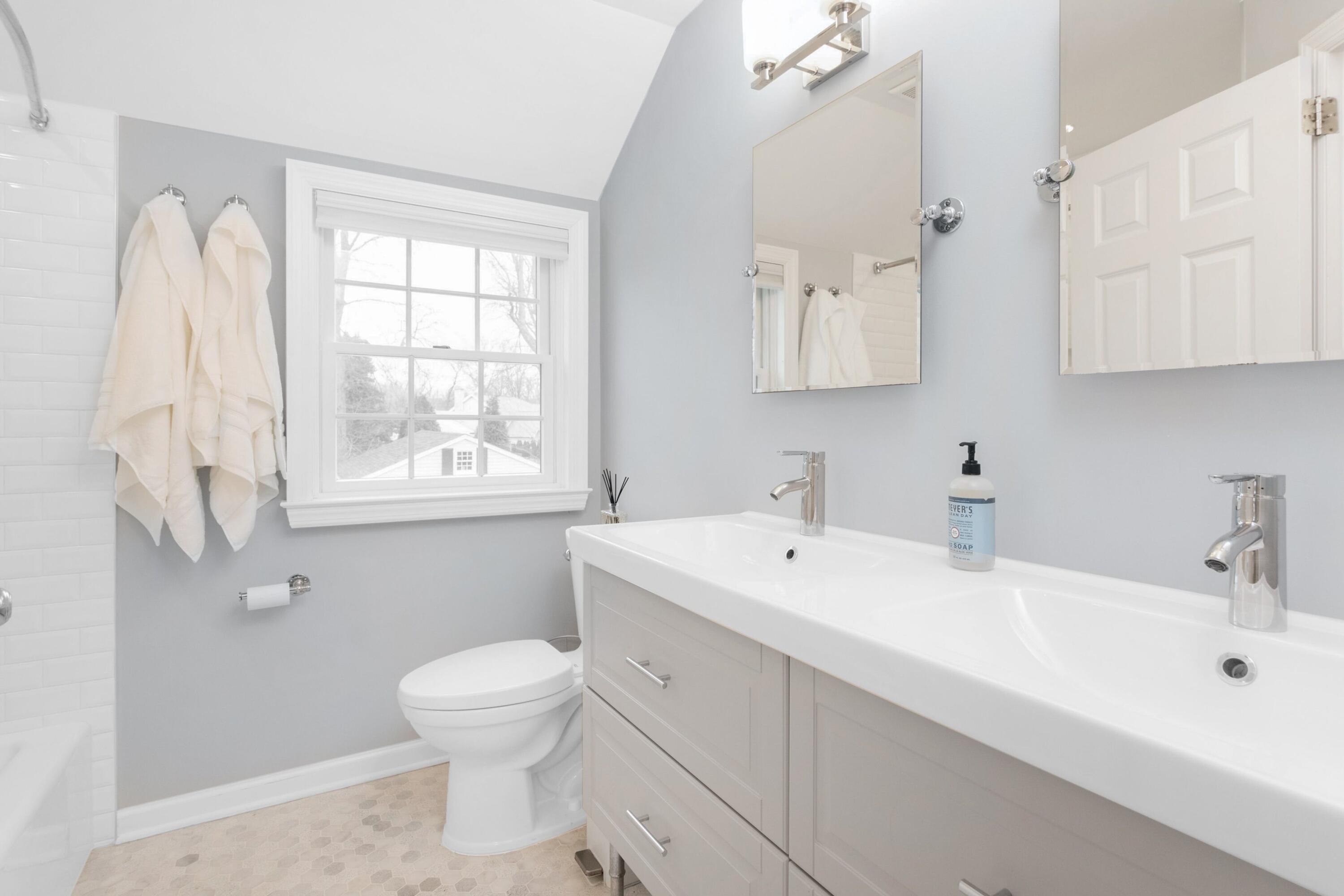 103 Hollow Tree Ridge Road Darien, CT 06820 - Photo 21 of 35 a bathroom with a toilet sink and mirror